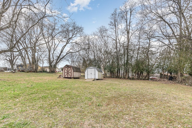 view of yard featuring an outbuilding and a storage shed