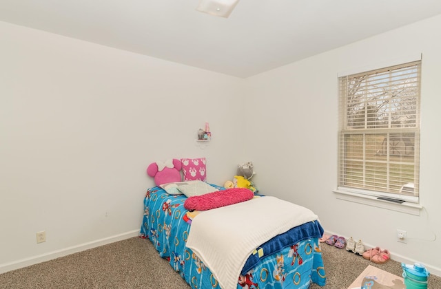 bedroom featuring baseboards and carpet flooring