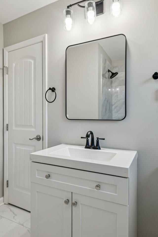 bathroom featuring marble finish floor and vanity