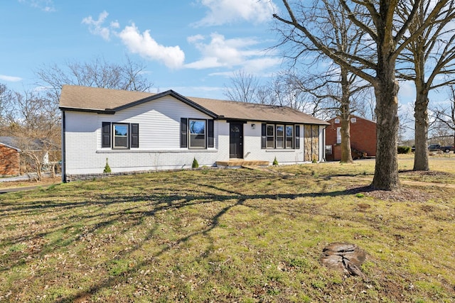 ranch-style house featuring brick siding and a front lawn