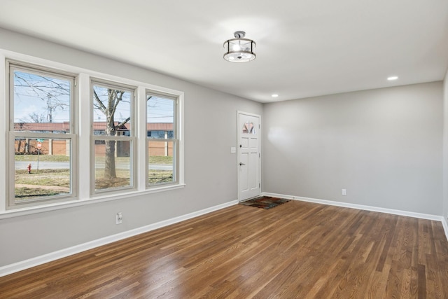 interior space featuring baseboards, dark wood finished floors, and recessed lighting