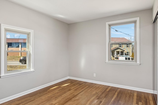 unfurnished room featuring wood finished floors and baseboards