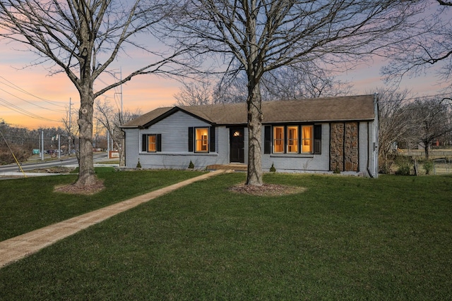 view of front facade with brick siding and a front yard