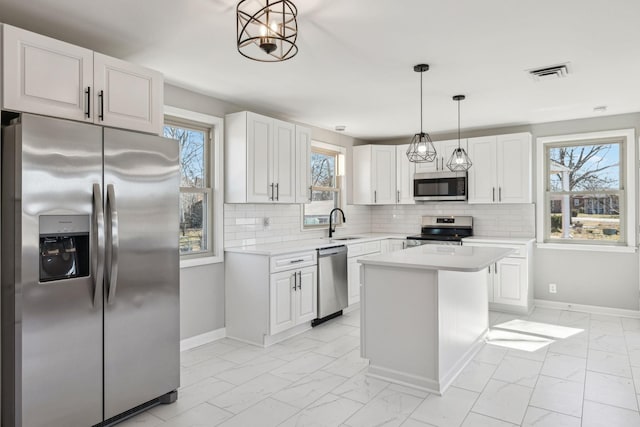 kitchen with marble finish floor, visible vents, appliances with stainless steel finishes, and light countertops