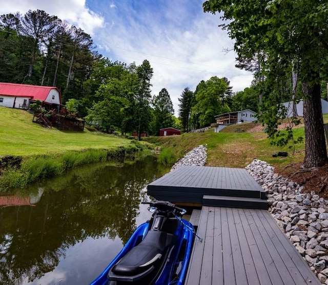 view of dock featuring a lawn