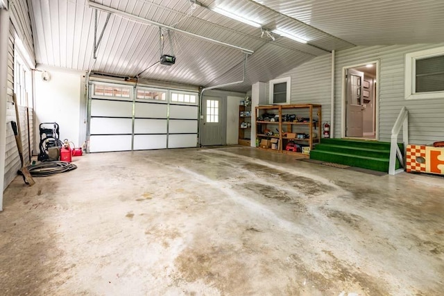 garage with metal wall and a garage door opener