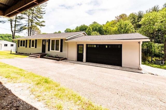 single story home with a garage and driveway