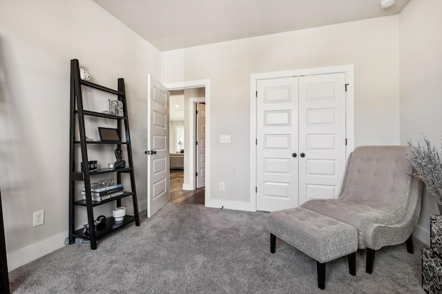 sitting room with carpet floors and baseboards