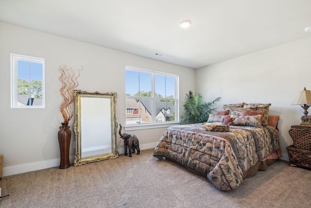 bedroom featuring carpet flooring, visible vents, and baseboards