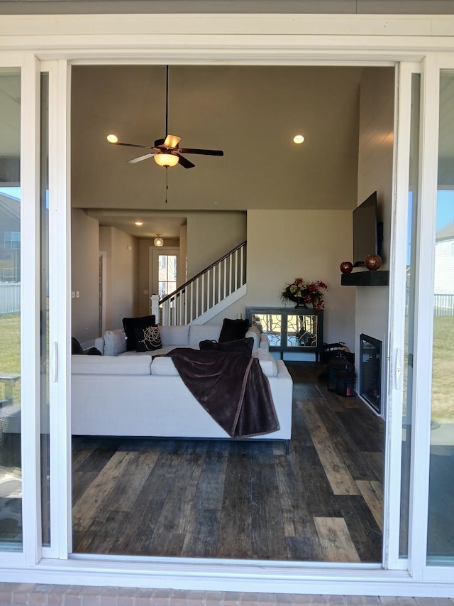 living room with recessed lighting, a glass covered fireplace, ceiling fan, hardwood / wood-style floors, and stairs