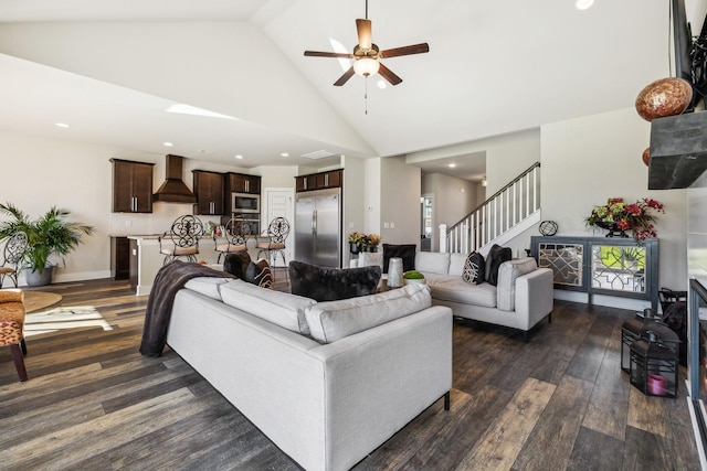 living area featuring ceiling fan, dark wood-type flooring, stairs, high vaulted ceiling, and recessed lighting