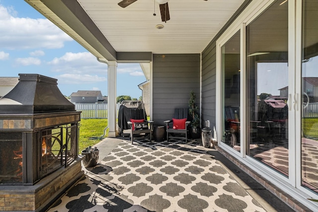 view of patio featuring fence and ceiling fan