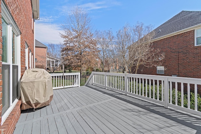 wooden terrace with a grill