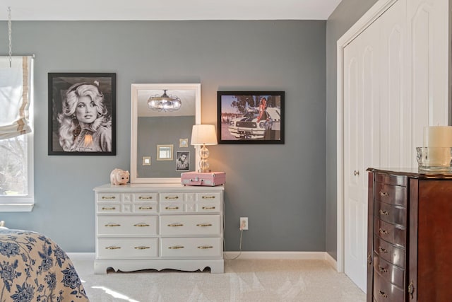 bedroom with light carpet and baseboards