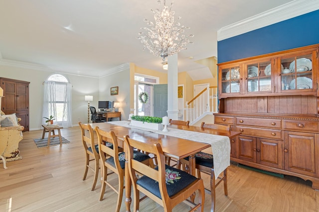 dining area featuring crown molding, light wood finished floors, stairway, a chandelier, and baseboards