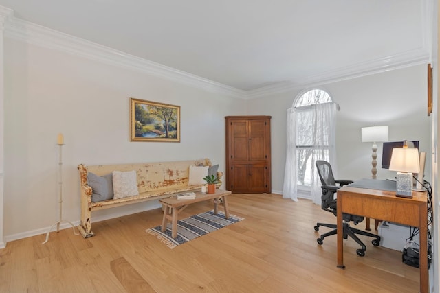 home office featuring crown molding, baseboards, and wood finished floors