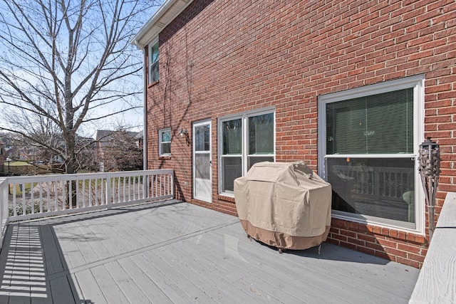 wooden deck with a grill