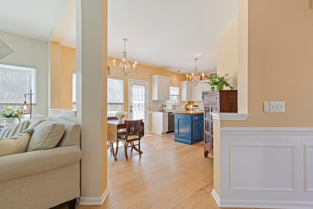 living room featuring light wood-style floors and a chandelier