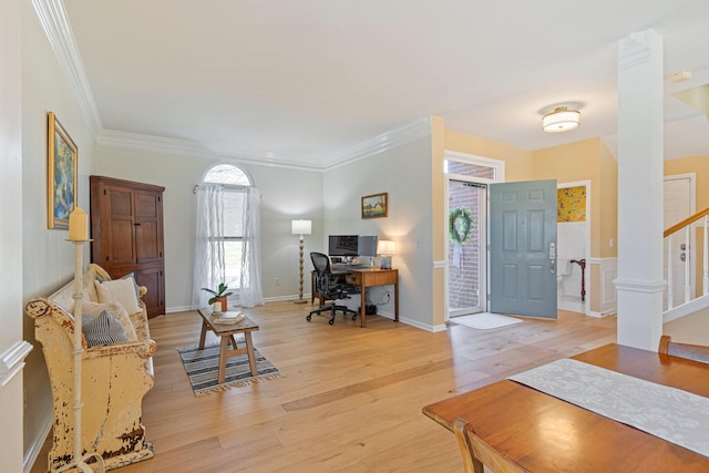 interior space featuring crown molding, light wood-style flooring, and baseboards