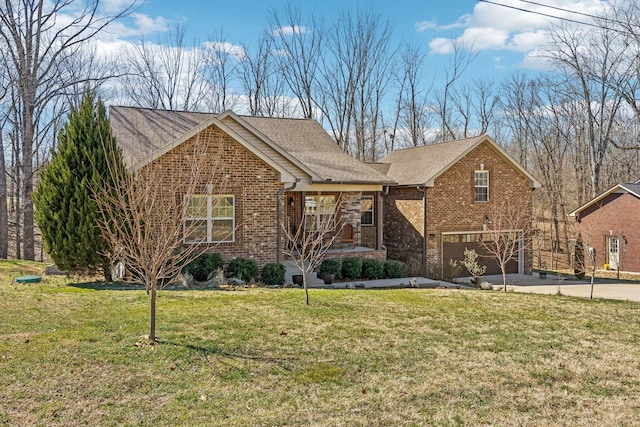 view of front of house with a garage, a front yard, brick siding, and driveway