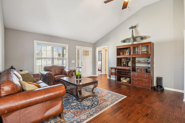 living area featuring high vaulted ceiling, ceiling fan, baseboards, and dark wood finished floors