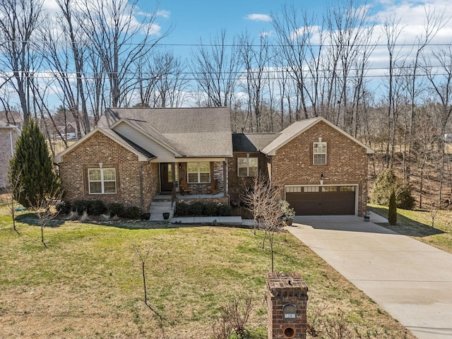 view of front of property with concrete driveway, an attached garage, a front lawn, a porch, and brick siding