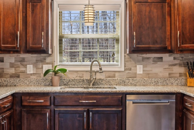 kitchen featuring dishwasher, tasteful backsplash, plenty of natural light, and a sink