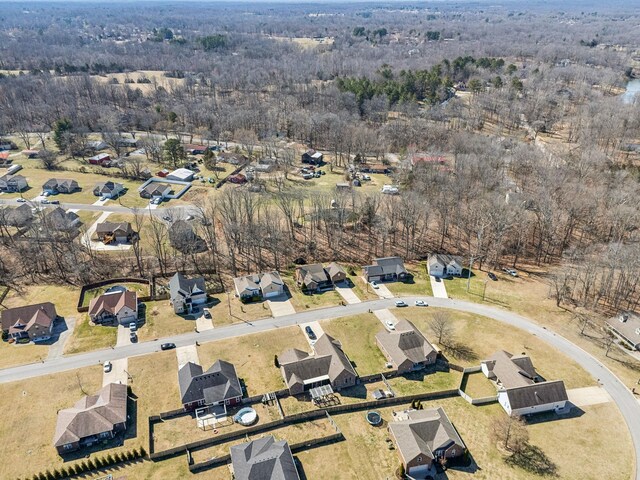 drone / aerial view with a forest view and a residential view