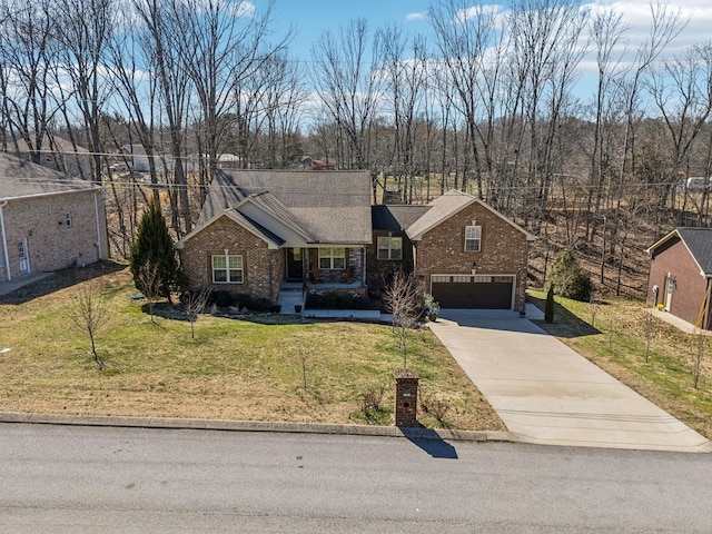 view of front of home with brick siding, roof with shingles, concrete driveway, a front yard, and a garage