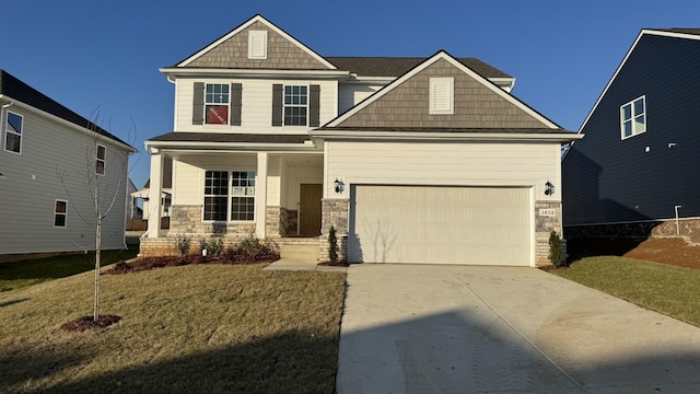 craftsman house featuring an attached garage, covered porch, driveway, stone siding, and a front lawn