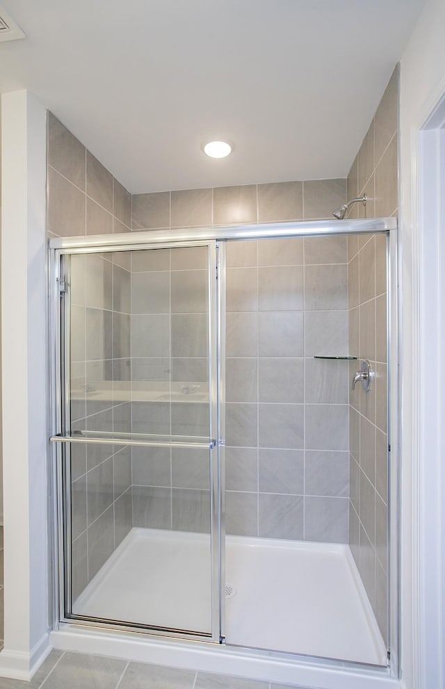 bathroom with visible vents and a shower stall