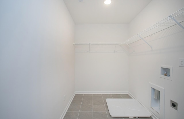 laundry area featuring tile patterned flooring, baseboards, laundry area, hookup for a washing machine, and hookup for an electric dryer