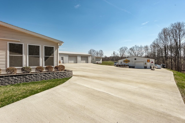 view of yard featuring a garage and an outdoor structure