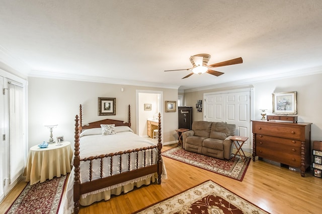 bedroom featuring light wood-style flooring, ornamental molding, ceiling fan, and connected bathroom