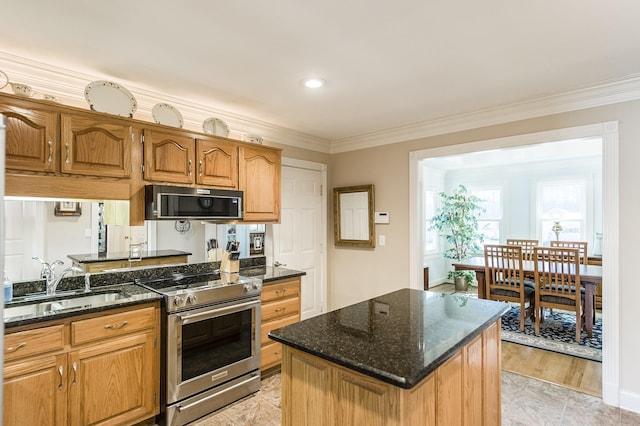 kitchen featuring a sink, dark stone countertops, crown molding, and electric stove