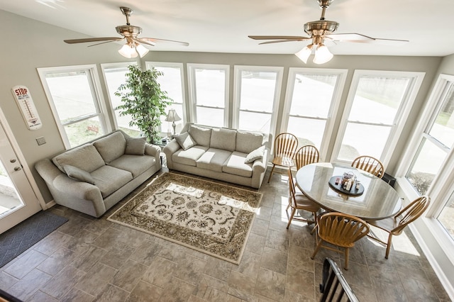 living area featuring a healthy amount of sunlight and ceiling fan