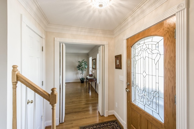 entryway featuring light wood-style flooring, ornamental molding, and baseboards