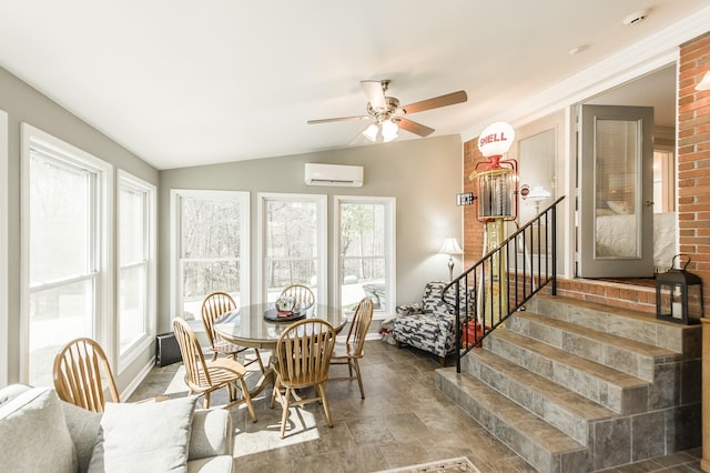 dining room featuring lofted ceiling, stairway, an AC wall unit, stone finish floor, and ceiling fan