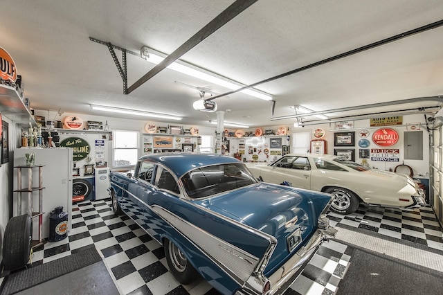 garage featuring electric panel and a garage door opener