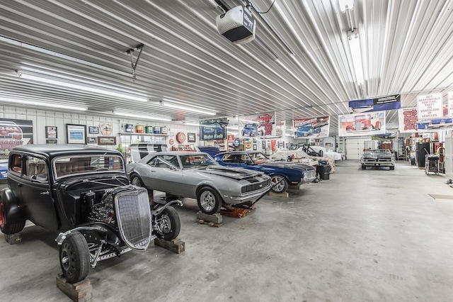 garage featuring metal wall and a garage door opener