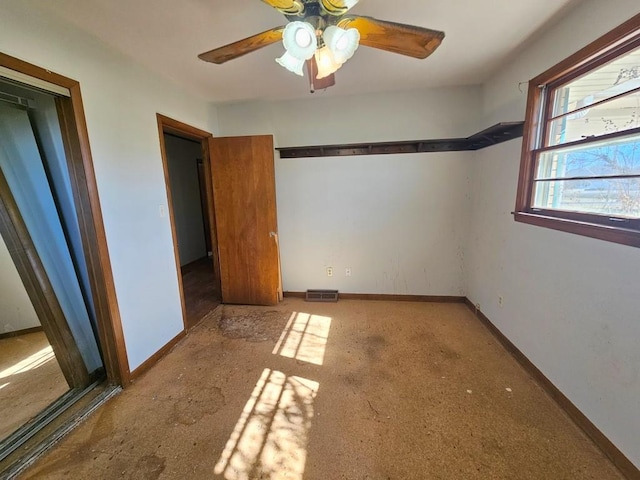 unfurnished bedroom featuring baseboards, visible vents, and ceiling fan