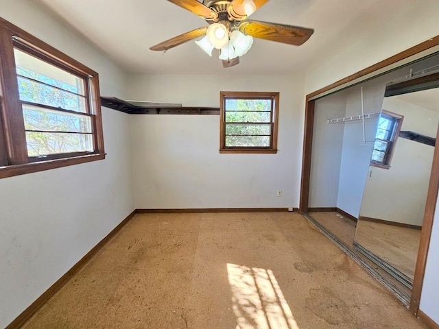 unfurnished bedroom with a ceiling fan, a closet, and baseboards