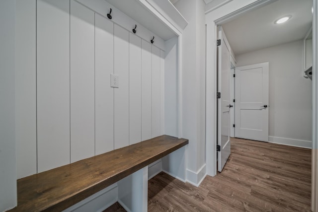 mudroom featuring baseboards and wood finished floors