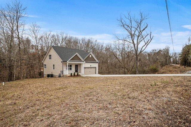 view of front of house with a garage and central AC unit