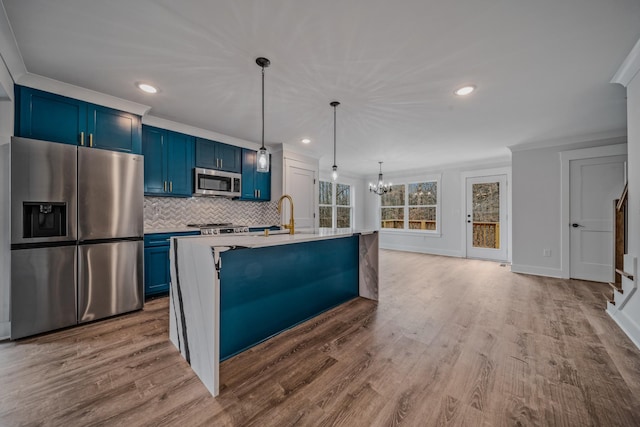 kitchen with decorative backsplash, wood finished floors, stainless steel appliances, light countertops, and blue cabinetry