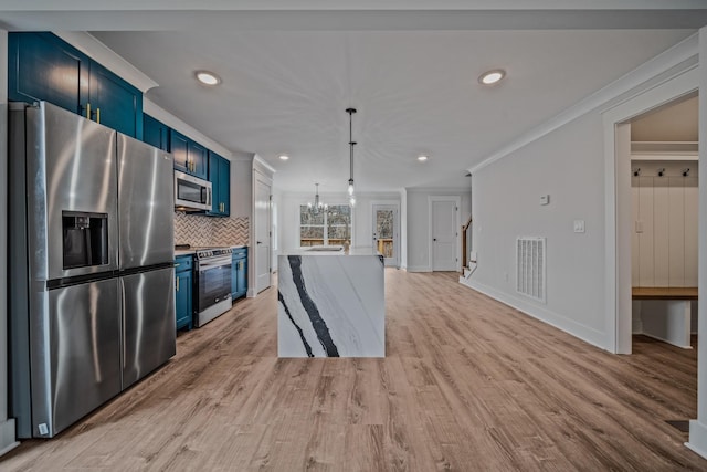 kitchen featuring stainless steel appliances, visible vents, ornamental molding, blue cabinetry, and decorative backsplash