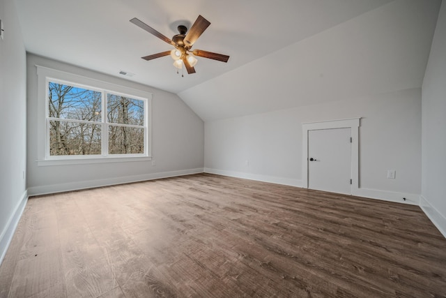 bonus room with lofted ceiling, visible vents, ceiling fan, wood finished floors, and baseboards