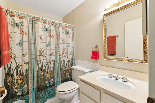 bathroom with toilet, a shower with shower curtain, tile walls, and vanity