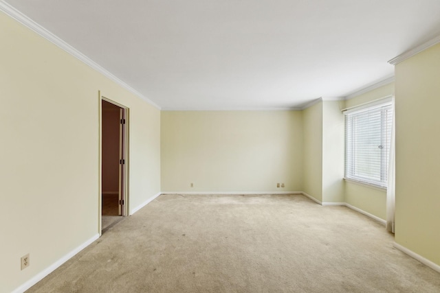 unfurnished room featuring light colored carpet, crown molding, and baseboards