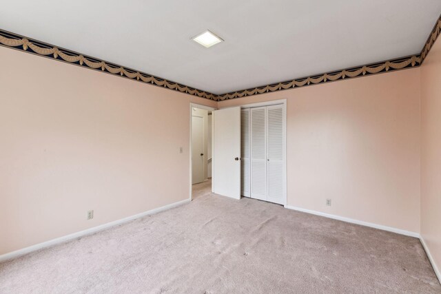 spare room with carpet and baseboards